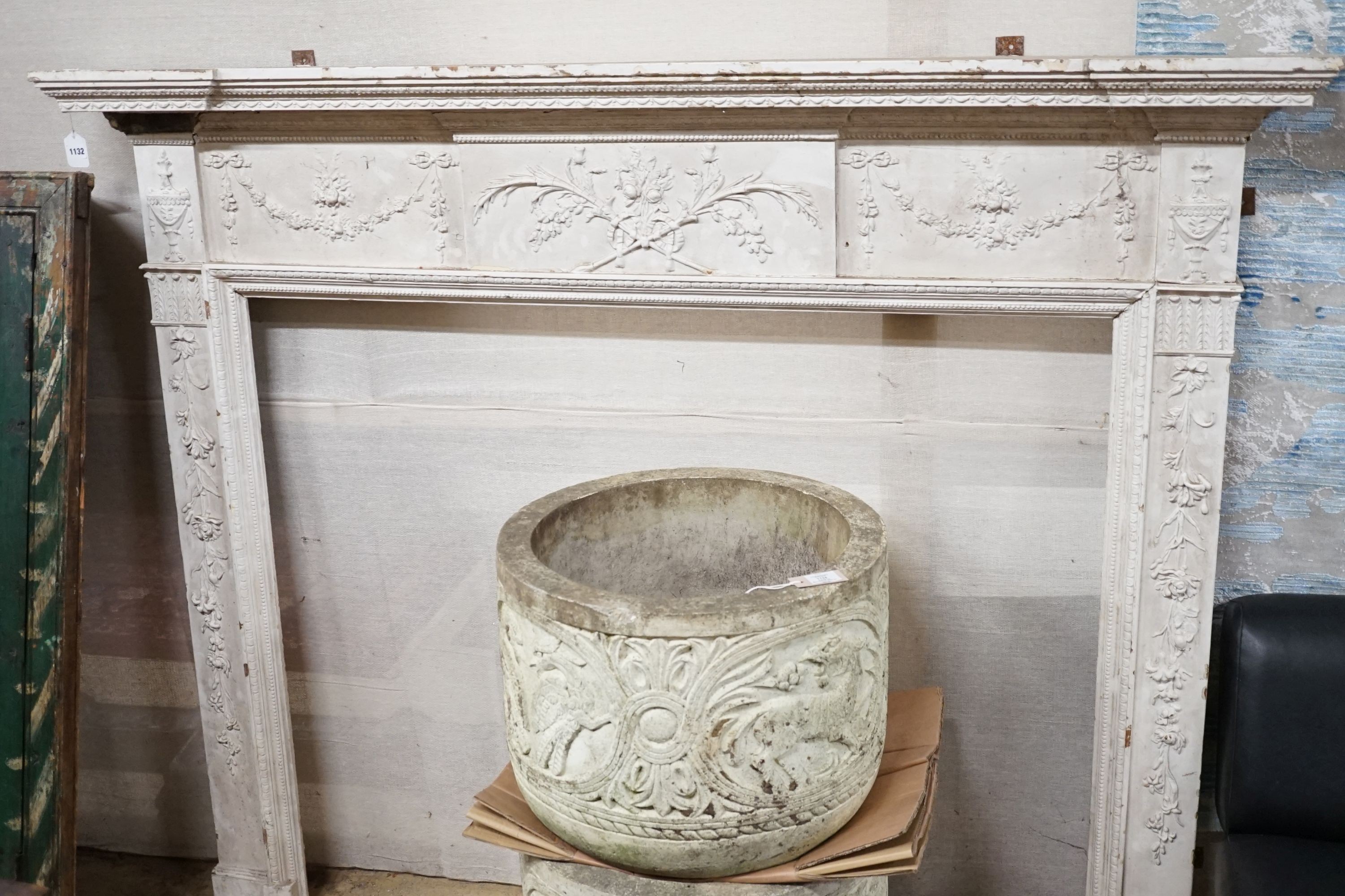 An Edwardian white painted gesso and pine fire surround, width 183cm, height 145cm, aperture width 131cm, height 108cm